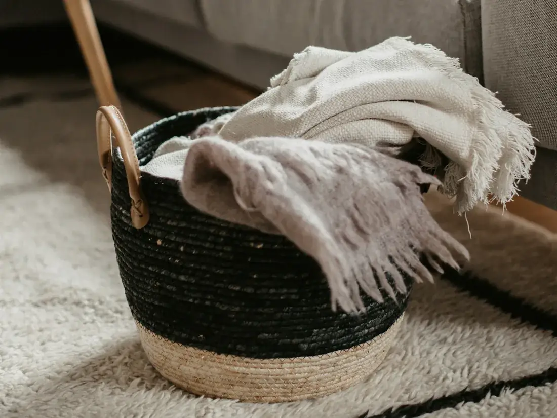 Woven basket with throws in a living room